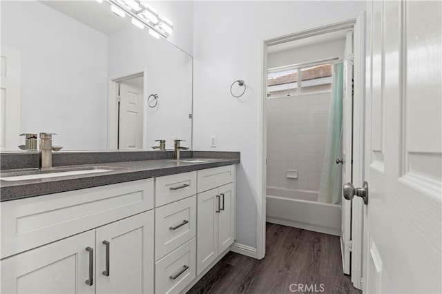 6219 S Kingsmill Ct, Fontana, CA 92336 - full bath featuring double vanity, wood finished floors, and bathing tub / shower combination