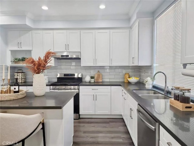 6219 S Kingsmill Ct, Fontana, CA 92336 - kitchen featuring stainless steel appliances, under cabinet range hood, dark countertops, white cabinets, and recessed lighting