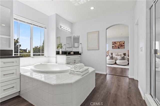 6219 S Kingsmill Ct, Fontana, CA 92336 - full bathroom with vanity, a garden tub, a shower stall, wood finished floors, and recessed lighting