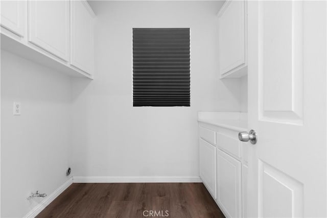 6219 S Kingsmill Ct, Fontana, CA 92336 - laundry room with dark wood-style flooring, hookup for a gas dryer, and cabinet space