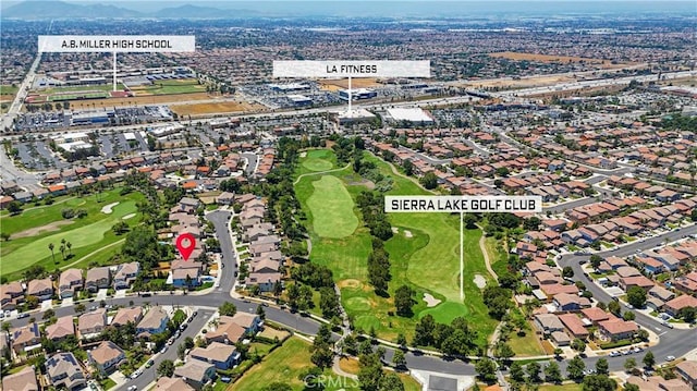 6219 S Kingsmill Ct, Fontana, CA 92336 - aerial overview of property's location with a local golf course and mountains
