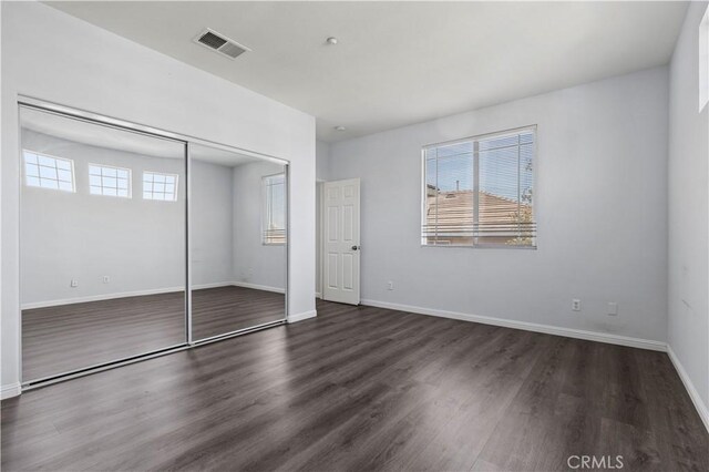 6219 S Kingsmill Ct, Fontana, CA 92336 - unfurnished bedroom with wood finished floors and a closet