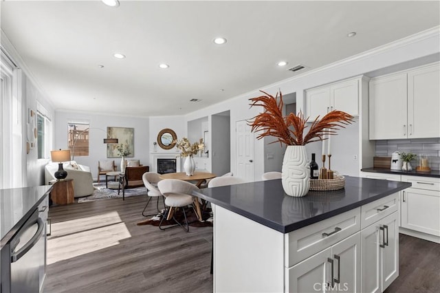 6219 S Kingsmill Ct, Fontana, CA 92336 - kitchen featuring dark countertops, ornamental molding, dark wood-style floors, white cabinets, and recessed lighting