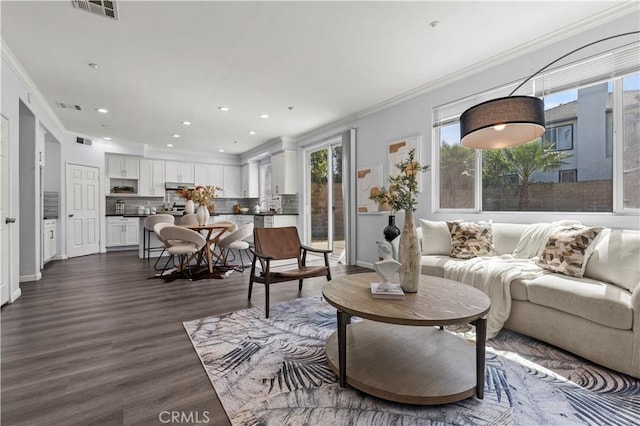 6219 S Kingsmill Ct, Fontana, CA 92336 - living area with crown molding, dark wood finished floors, and recessed lighting