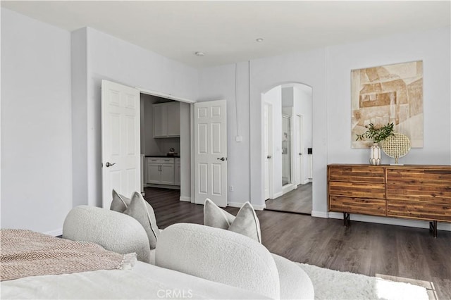 6219 S Kingsmill Ct, Fontana, CA 92336 - bedroom featuring arched walkways, wood finished floors, and connected bathroom