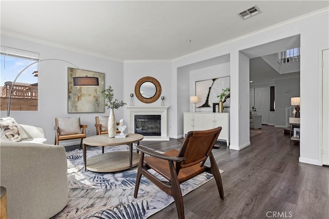 6219 S Kingsmill Ct, Fontana, CA 92336 - living room featuring dark wood-style floors, ornamental molding, and a glass covered fireplace
