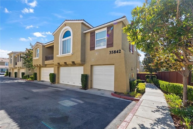 35842 Ellison Ln Unit 2, Murrieta, CA 92562 - townhome / multi-family property with stucco siding, a garage, and a tile roof