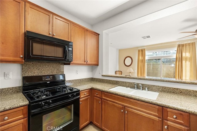 35842 Ellison Ln Unit 2, Murrieta, CA 92562 - kitchen with black appliances and brown cabinetry