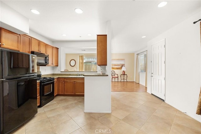 35842 Ellison Ln Unit 2, Murrieta, CA 92562 - kitchen with black appliances, recessed lighting, light tile patterned floors, and brown cabinetry
