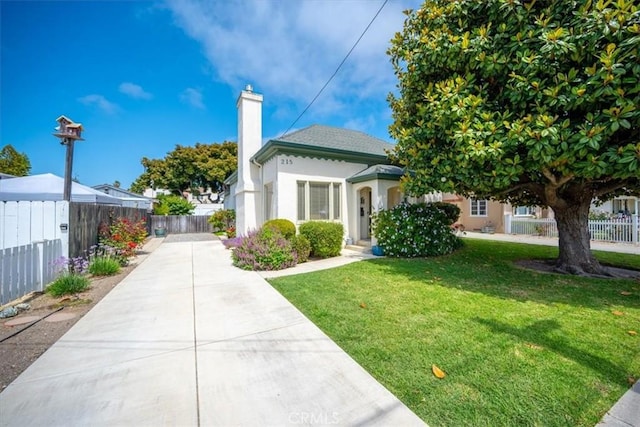 215 S Mason St, Arroyo Grande, CA 93420 - view of front of home with a chimney, driveway, and stucco siding