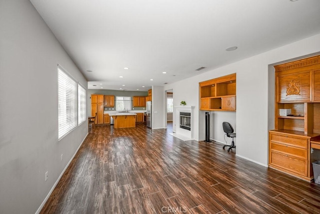 30118 Galbreth Ct, Castaic, CA 91384 - unfurnished living room with dark wood finished floors, plenty of natural light, a glass covered fireplace, and recessed lighting