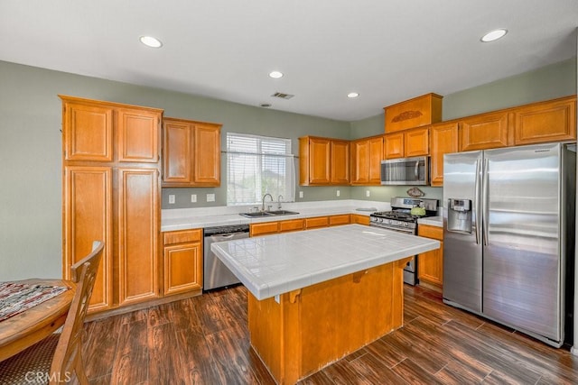 30118 Galbreth Ct, Castaic, CA 91384 - kitchen featuring stainless steel appliances, tile counters, a center island, dark wood-style floors, and recessed lighting