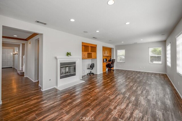 30118 Galbreth Ct, Castaic, CA 91384 - unfurnished living room featuring dark wood-style floors, recessed lighting, and a glass covered fireplace
