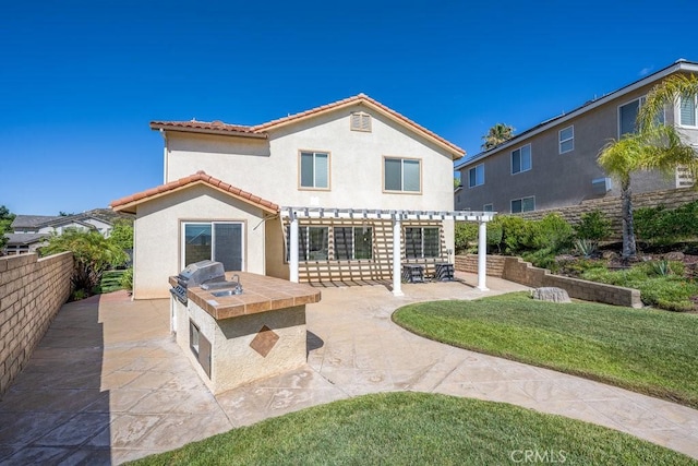 30118 Galbreth Ct, Castaic, CA 91384 - back of house with area for grilling, a pergola, stucco siding, a patio area, and a tiled roof