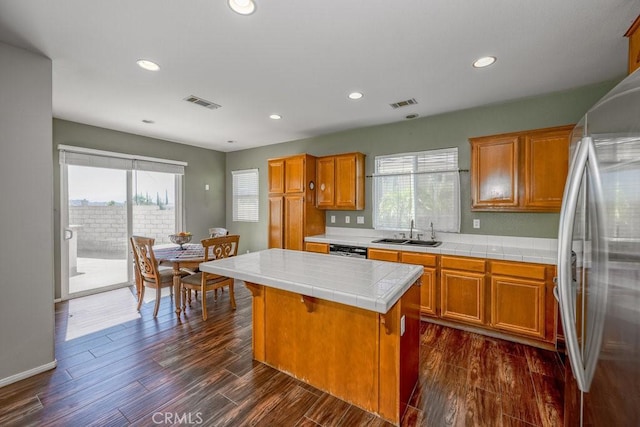 30118 Galbreth Ct, Castaic, CA 91384 - kitchen featuring freestanding refrigerator, tile counters, dark wood-style floors, brown cabinets, and recessed lighting