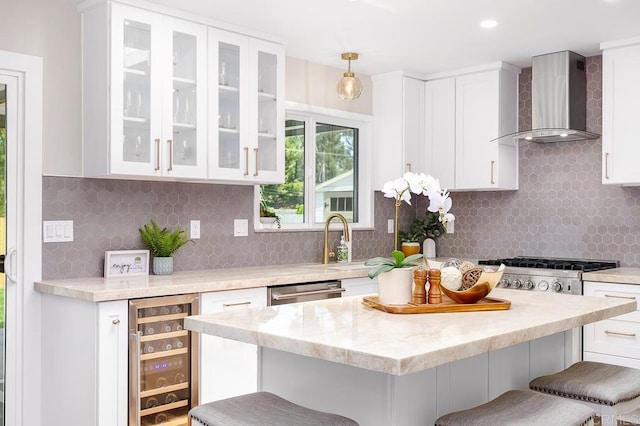 6270 Meadowcrest Dr, La Mesa, CA 91942 - kitchen featuring wall chimney exhaust hood, beverage cooler, a breakfast bar area, white cabinets, and recessed lighting