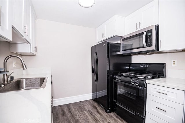 1000 Central Ave Unit 19, Riverside, CA 92507 - kitchen with black range with gas stovetop, stainless steel microwave, light countertops, white cabinets, and dark wood finished floors