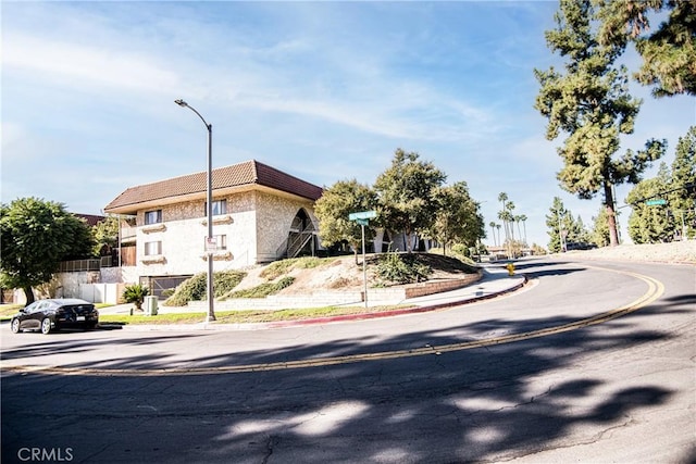1000 Central Ave Unit 19, Riverside, CA 92507 - view of asphalt road featuring street lights, curbs, and sidewalks