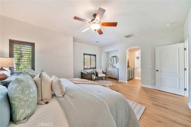8 Caltrop Way, Ladera Ranch, CA 92694 - bedroom featuring arched walkways, light wood-style flooring, multiple windows, and a ceiling fan