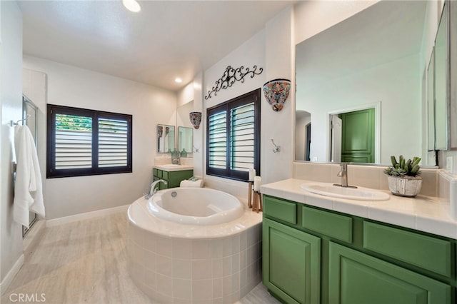 8 Caltrop Way, Ladera Ranch, CA 92694 - bathroom featuring a garden tub, two vanities, wood finished floors, and a shower
