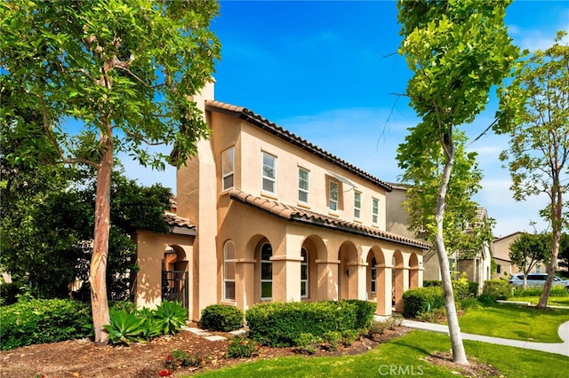 8 Caltrop Way, Ladera Ranch, CA 92694 - mediterranean / spanish-style home with stucco siding, a tile roof, and a front lawn