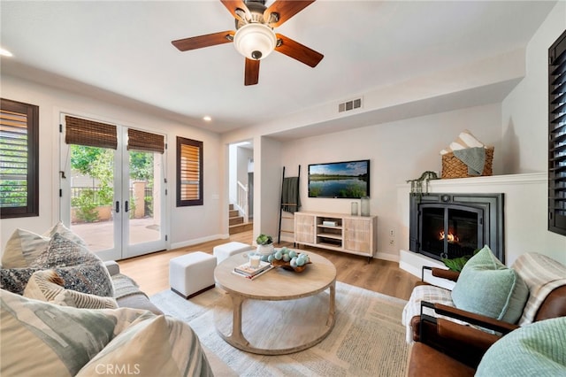 8 Caltrop Way, Ladera Ranch, CA 92694 - living room featuring french doors, plenty of natural light, wood finished floors, a lit fireplace, and recessed lighting