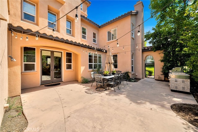 8 Caltrop Way, Ladera Ranch, CA 92694 - back of house featuring stucco siding, a chimney, a patio area, french doors, and a tile roof