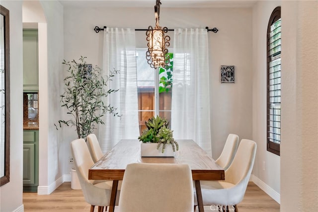 8 Caltrop Way, Ladera Ranch, CA 92694 - dining area with light wood-style floors, a chandelier, and healthy amount of natural light