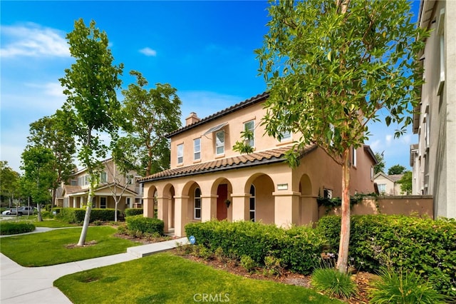 8 Caltrop Way, Ladera Ranch, CA 92694 - mediterranean / spanish-style home with stucco siding, a chimney, a front lawn, and a tiled roof
