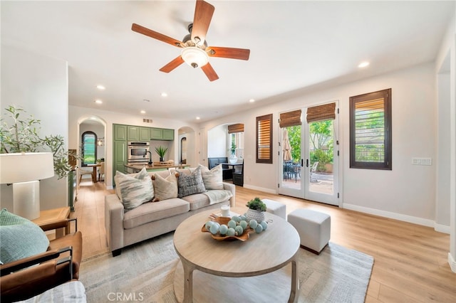 8 Caltrop Way, Ladera Ranch, CA 92694 - living room with arched walkways, recessed lighting, light wood-type flooring, and ceiling fan