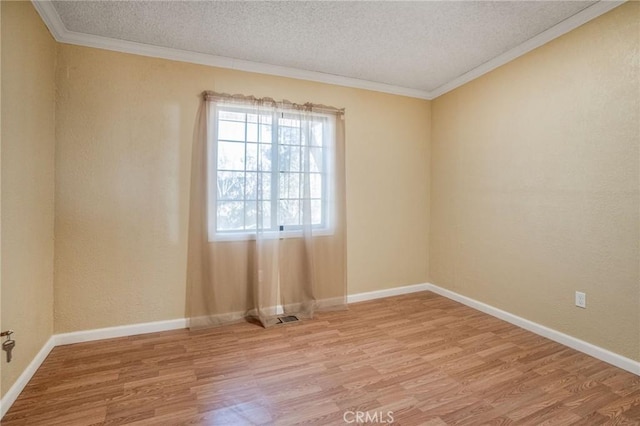 49750 Three Points Rd, Lancaster, CA 93536 - spare room with a textured ceiling, wood finished floors, and crown molding