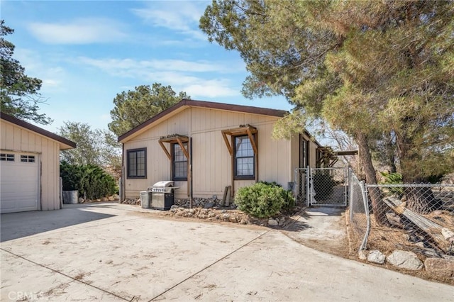 49750 Three Points Rd, Lancaster, CA 93536 - view of front of house featuring concrete driveway, a gate, and a garage