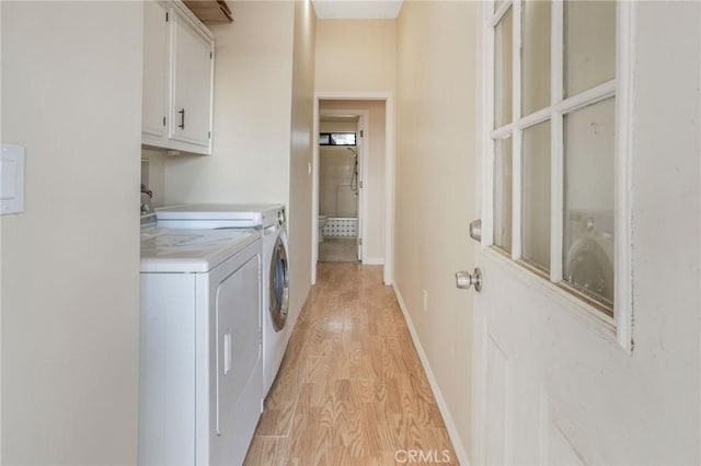 49750 Three Points Rd, Lancaster, CA 93536 - laundry area featuring cabinet space, light wood-type flooring, and washing machine and clothes dryer