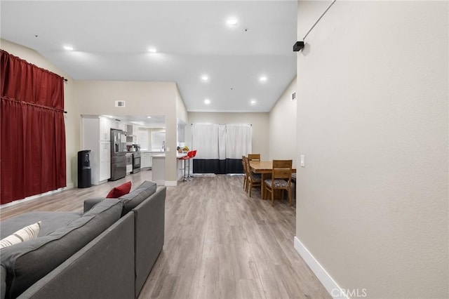 7550 Periwinkle Dr, Fontana, CA 92336 - living area with light wood-style flooring and recessed lighting