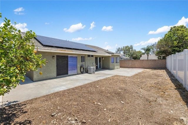 7550 Periwinkle Dr, Fontana, CA 92336 - rear view of property with a fenced backyard, stucco siding, a patio, and roof mounted solar panels