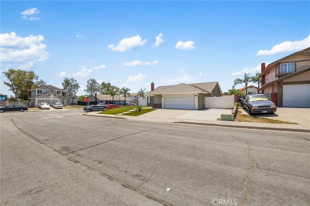 7550 Periwinkle Dr, Fontana, CA 92336 - view of asphalt road with a residential view, sidewalks, traffic signs, and curbs