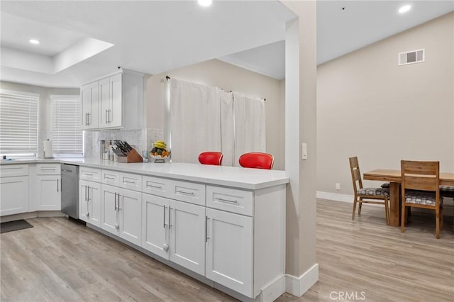 7550 Periwinkle Dr, Fontana, CA 92336 - kitchen with light wood finished floors, stainless steel dishwasher, tasteful backsplash, recessed lighting, and white cabinets
