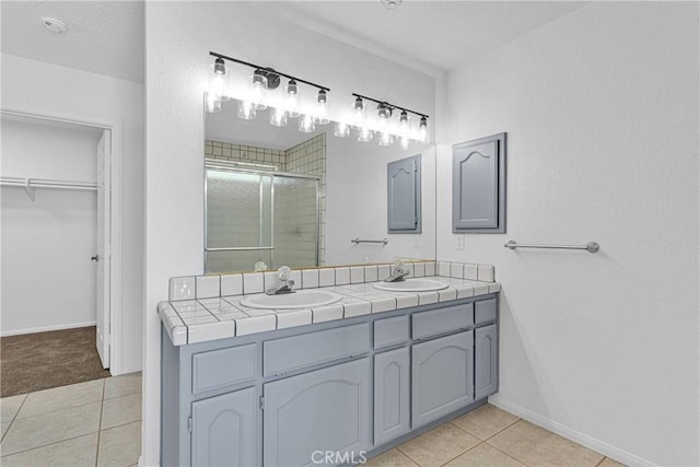 9191 White Rd, Phelan, CA 92371 - bathroom featuring a stall shower, double vanity, tile patterned floors, and a walk in closet