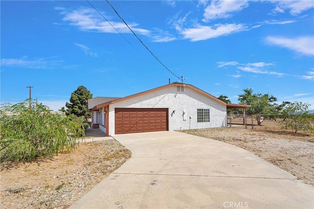 9191 White Rd, Phelan, CA 92371 - view of front of property featuring a garage, stucco siding, and driveway
