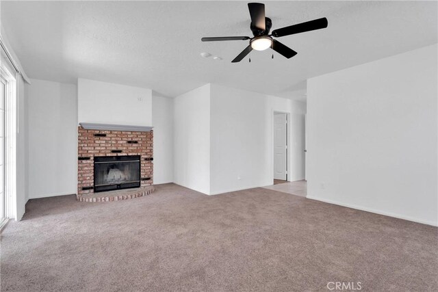 9191 White Rd, Phelan, CA 92371 - unfurnished living room with carpet flooring, a ceiling fan, and a brick fireplace