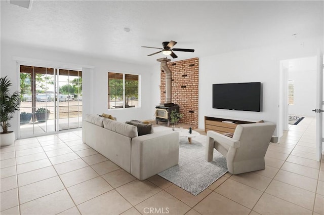 9191 White Rd, Phelan, CA 92371 - living room with a wood stove, light tile patterned flooring, and ceiling fan