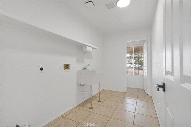 9191 White Rd, Phelan, CA 92371 - laundry room with washer hookup, light tile patterned floors, and hookup for an electric dryer