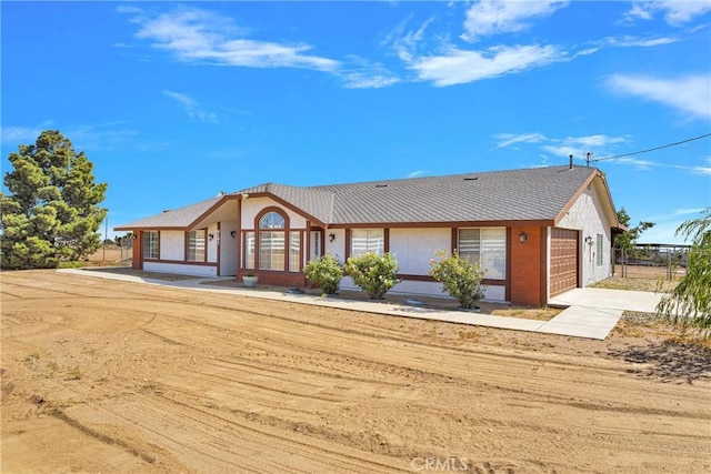 9191 White Rd, Phelan, CA 92371 - ranch-style home with concrete driveway, a garage, and stucco siding