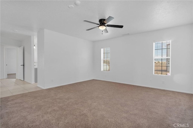 9191 White Rd, Phelan, CA 92371 - empty room featuring light colored carpet, plenty of natural light, and ceiling fan