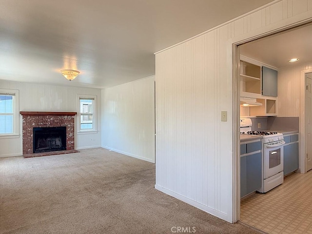 569 Huntington Rd, Cambria, CA 93428 - unfurnished living room with healthy amount of natural light, light colored carpet, and a brick fireplace