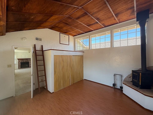 569 Huntington Rd, Cambria, CA 93428 - unfurnished living room with wooden ceiling, a wood stove, wood finished floors, and lofted ceiling