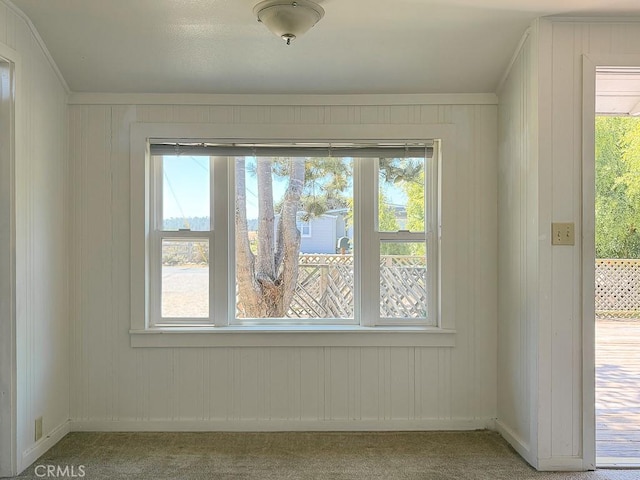 569 Huntington Rd, Cambria, CA 93428 - carpeted empty room featuring ornamental molding and wooden walls