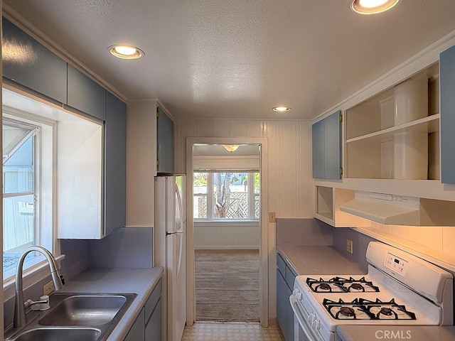 569 Huntington Rd, Cambria, CA 93428 - kitchen with white appliances, open shelves, recessed lighting, a textured ceiling, and light countertops