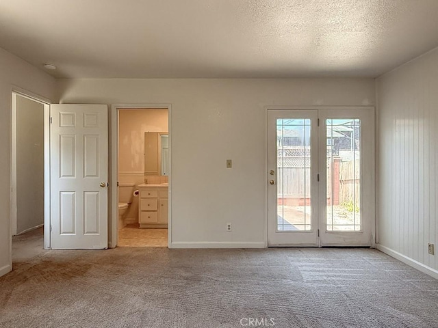 569 Huntington Rd, Cambria, CA 93428 - unfurnished bedroom featuring access to outside, light carpet, and ensuite bath