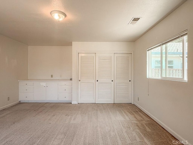 569 Huntington Rd, Cambria, CA 93428 - unfurnished bedroom featuring light colored carpet and a closet